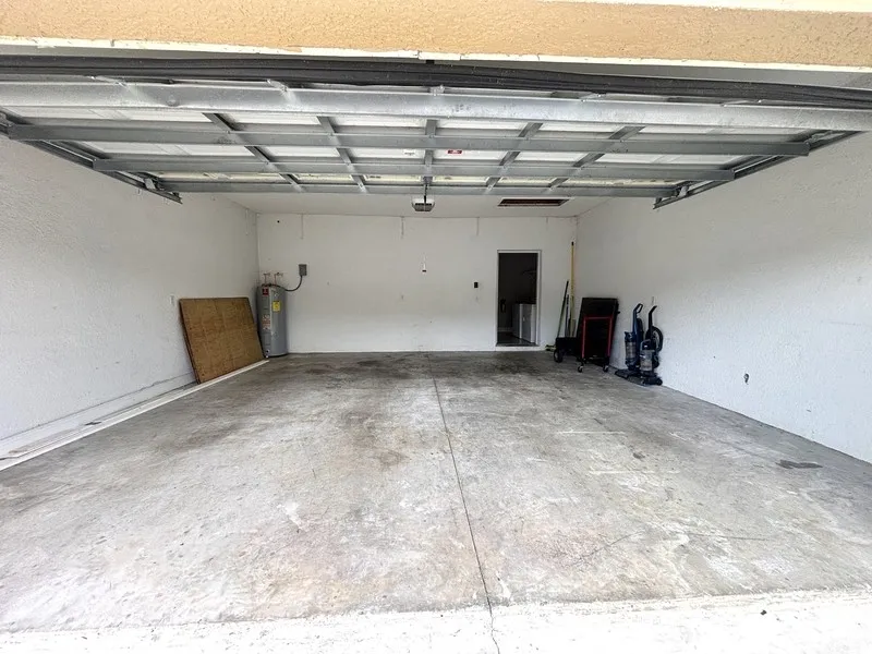Before — bare, stained concrete garage slab