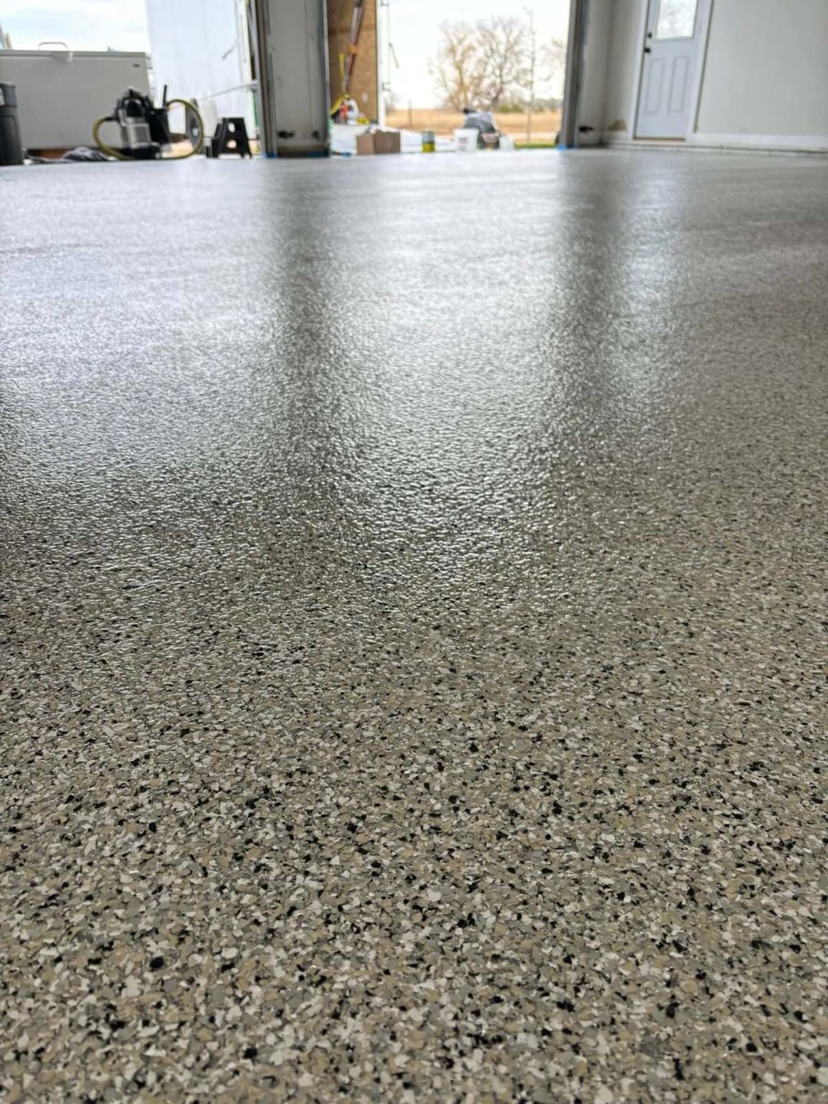After — the same shop floor finished with a flake coating