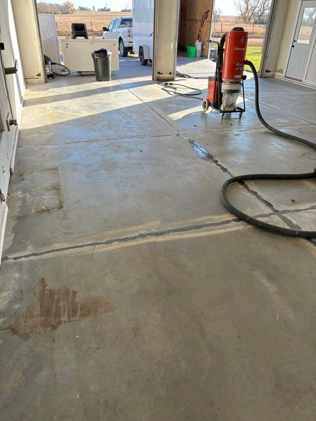 Before — bare shop concrete during diamond grinding prep
