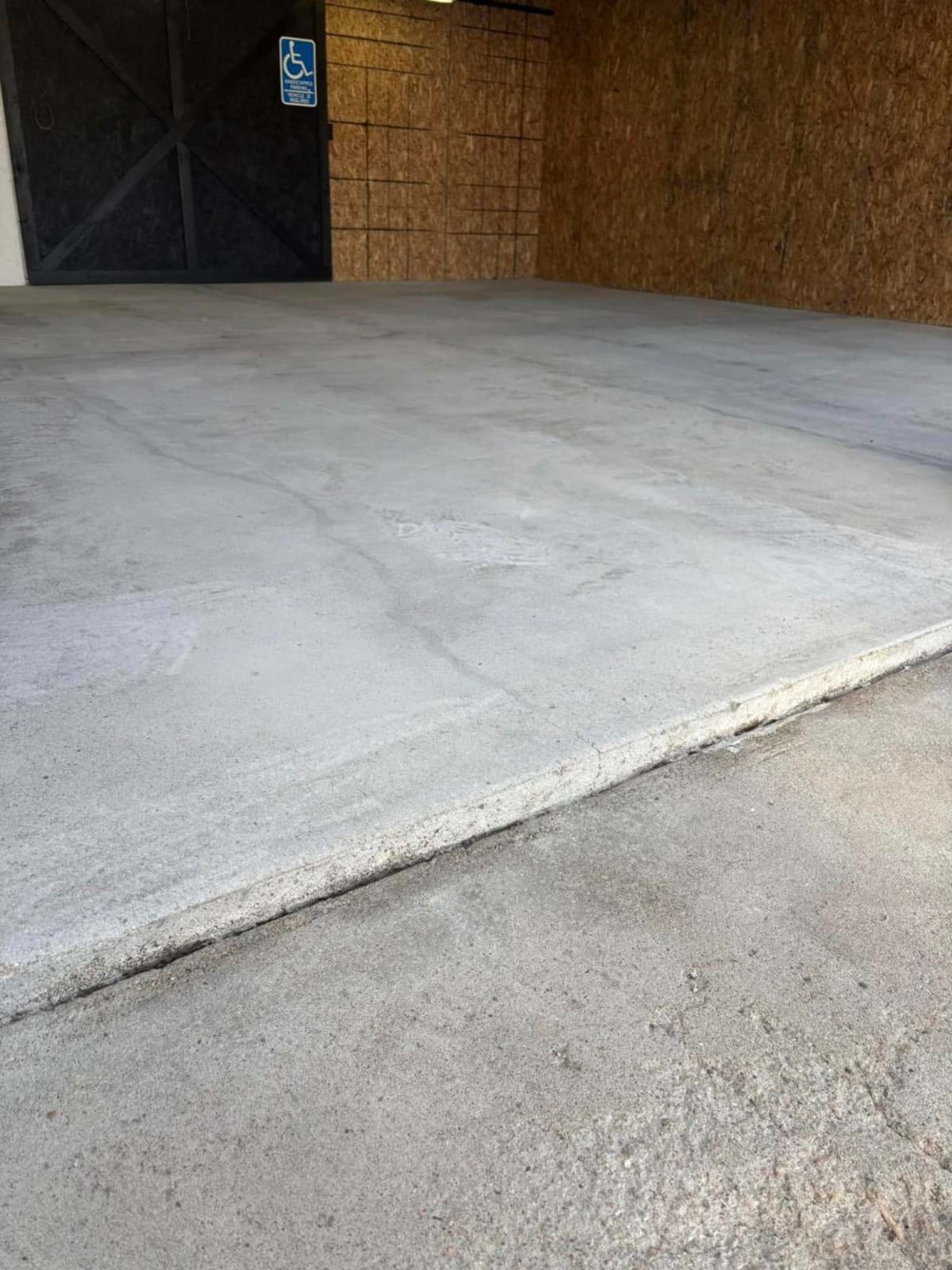 Before — bare, weathered concrete slab at a shop entrance