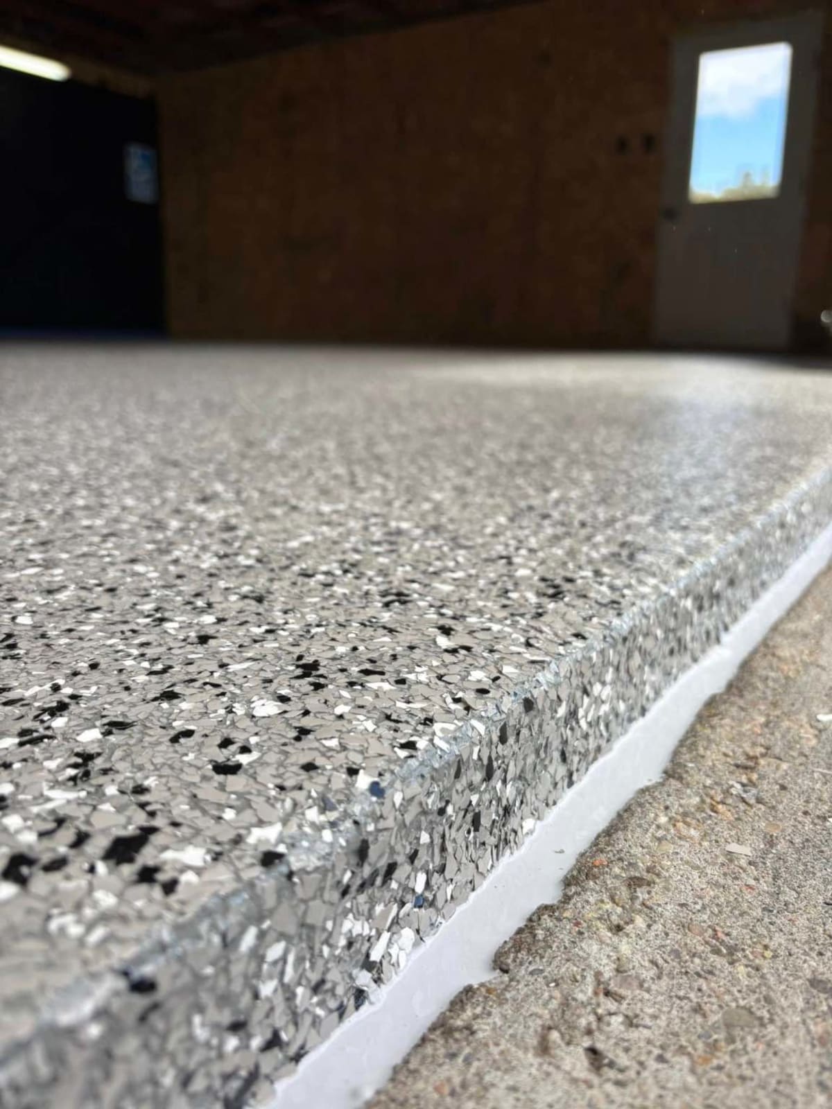 After — the same slab coated in flake with a sealed edge